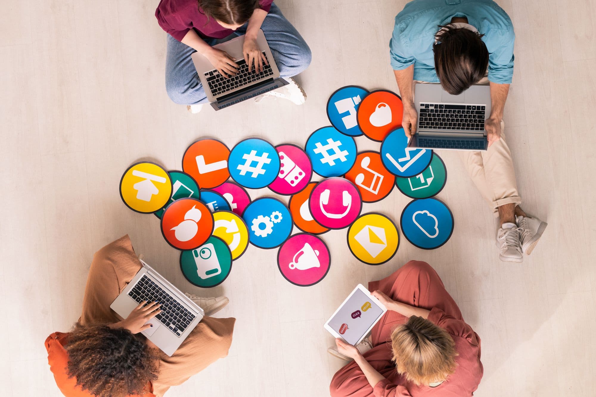 Team working on laptops surrounded by colourful social media icons